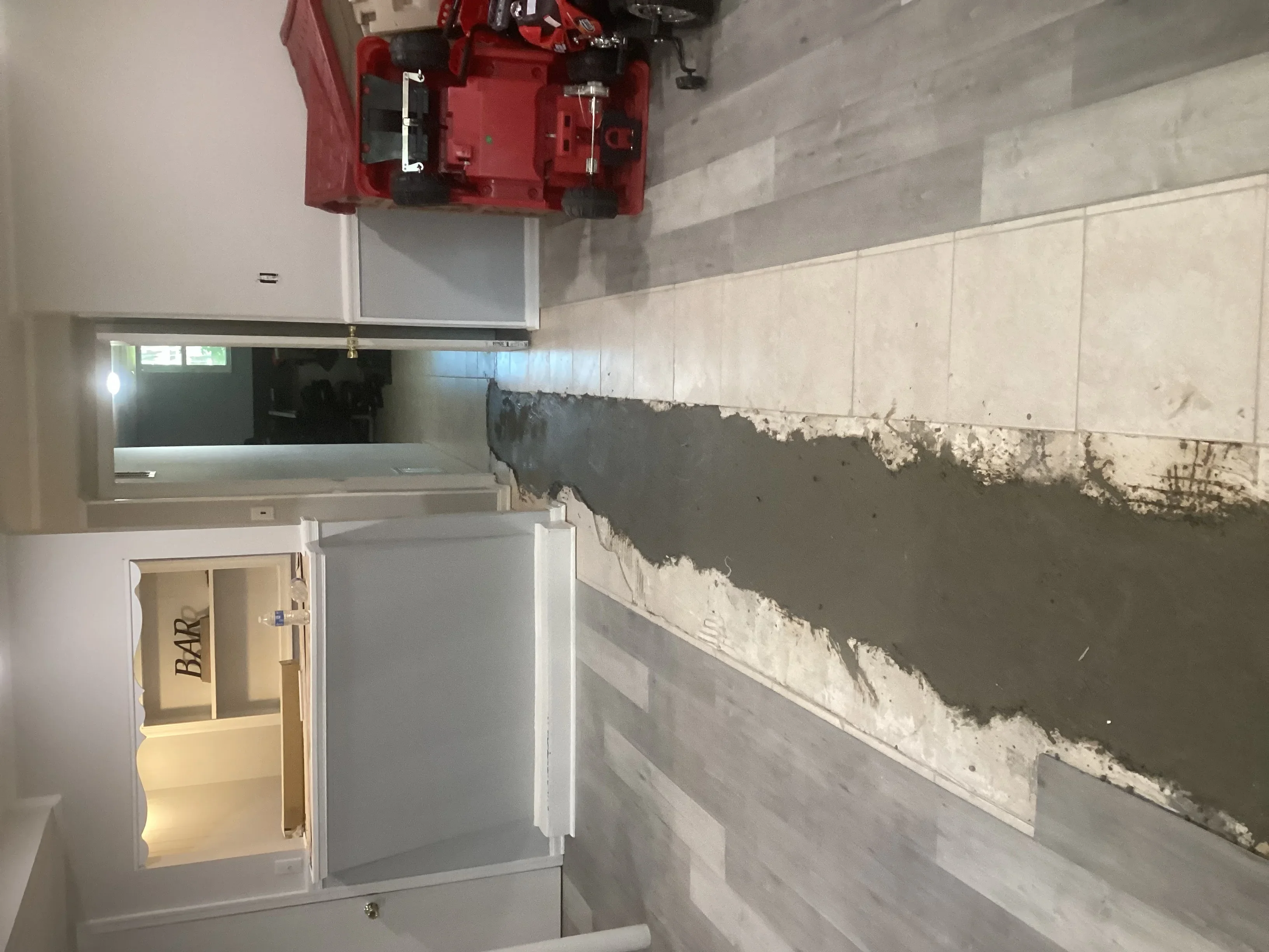 Commercial kitchen plumbing rough-in with supply lines, drains, and fire suppression system