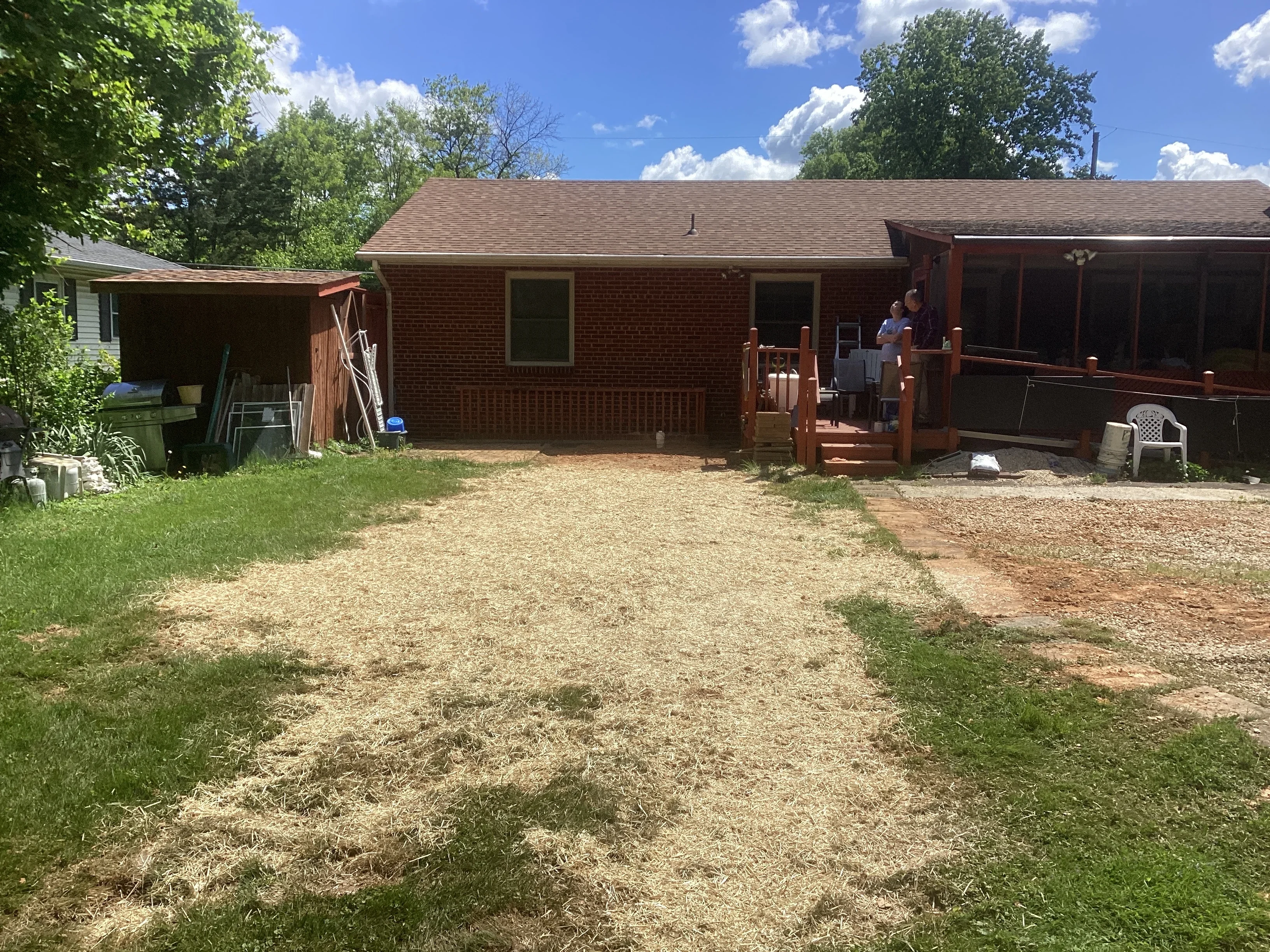 Brick home with freshly graded yard and gravel drainage work completed