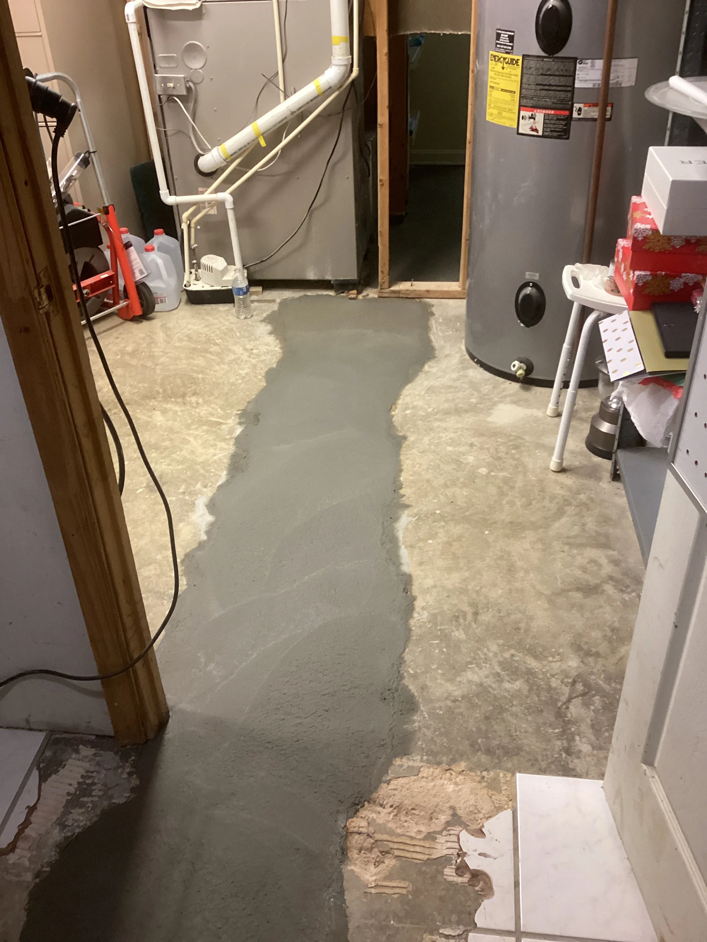 Basement floor preparation with concrete removal and leveling compound applied