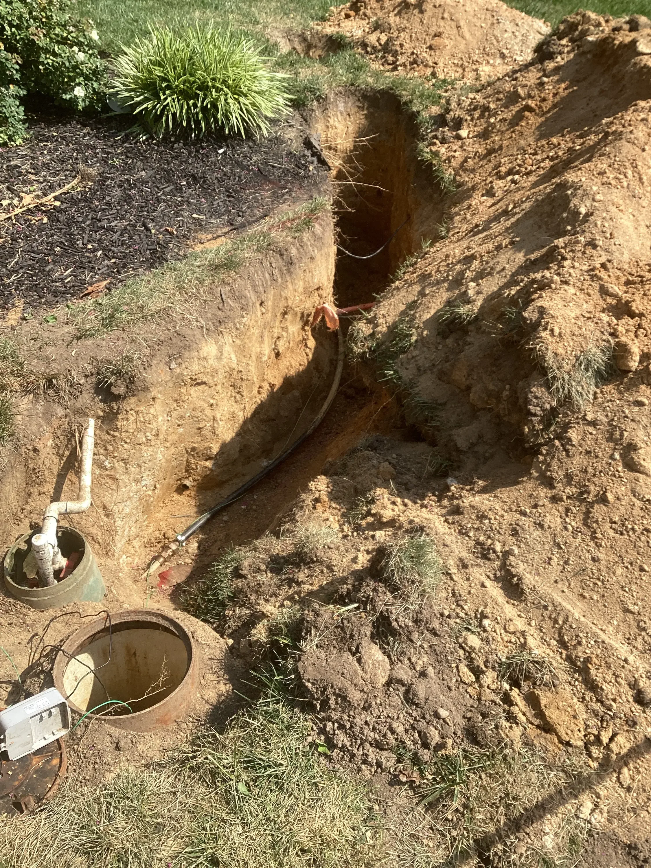 Septic tank excavation with distribution lines and access ports in Manassas