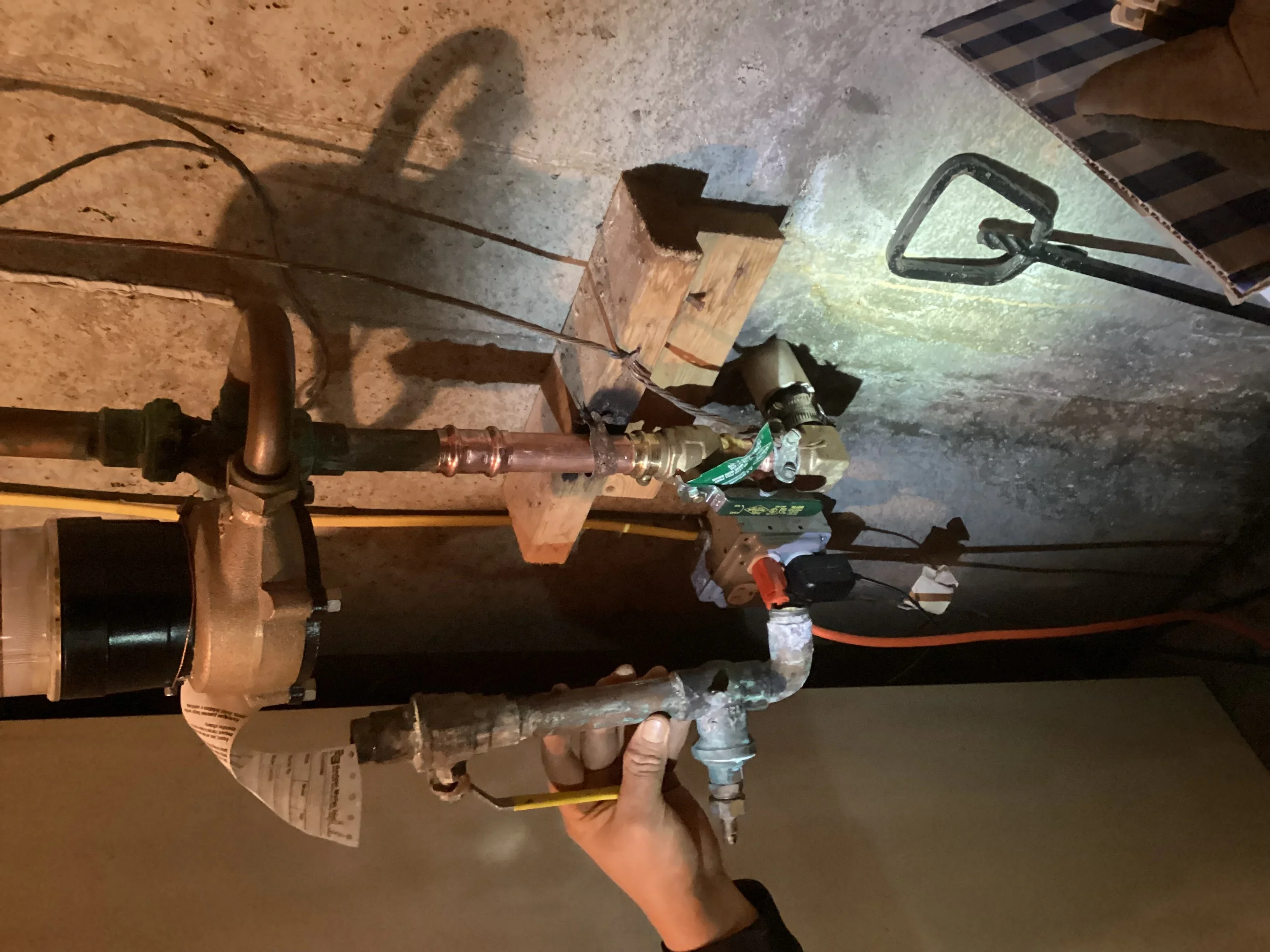 Copper water line with ball valve and pressure relief valve installed underground